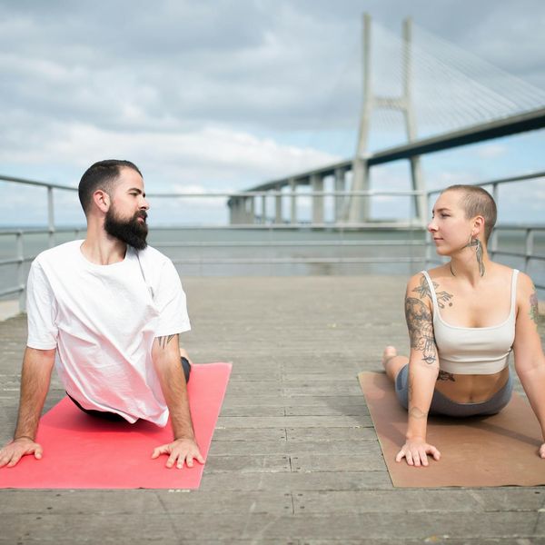 Person stretching outdoors, symbolizing flexibility and connection with nature.